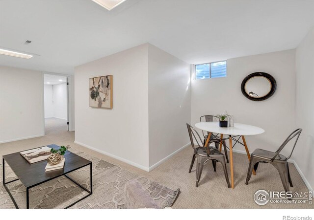 carpeted dining room with baseboards