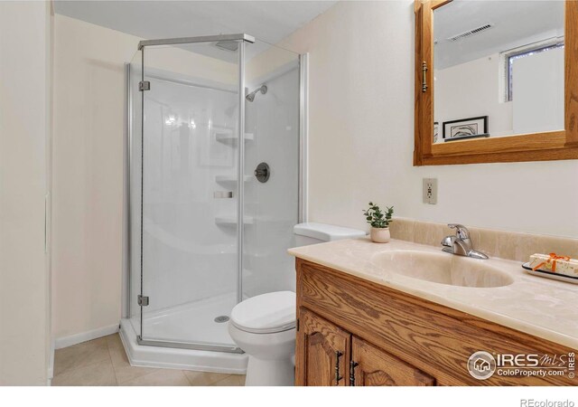 full bath with visible vents, toilet, a stall shower, tile patterned floors, and vanity