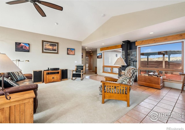 carpeted living area featuring tile patterned flooring, ceiling fan, lofted ceiling, recessed lighting, and a wood stove