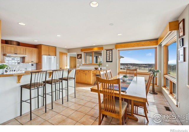 dining room with light tile patterned floors, visible vents, and recessed lighting