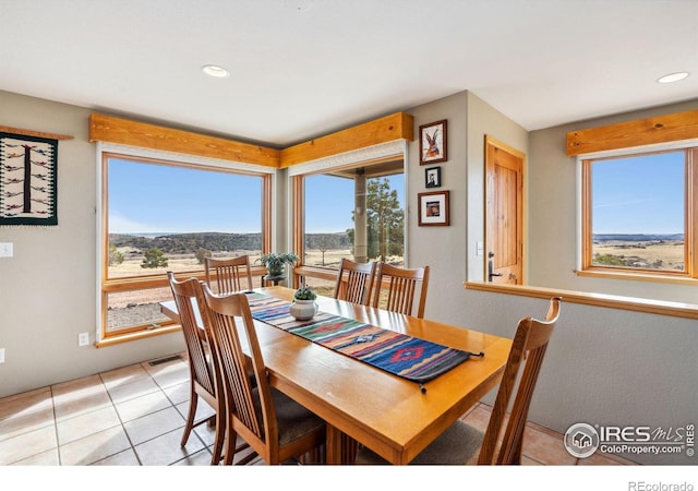 dining area with light tile patterned floors, a healthy amount of sunlight, and recessed lighting