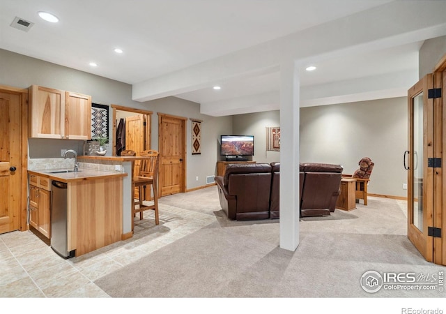 kitchen featuring a sink, beam ceiling, recessed lighting, and light countertops