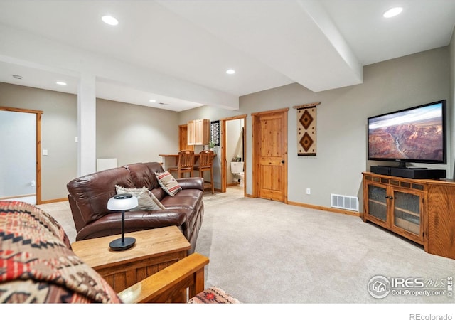 living area with visible vents, baseboards, beamed ceiling, light colored carpet, and recessed lighting