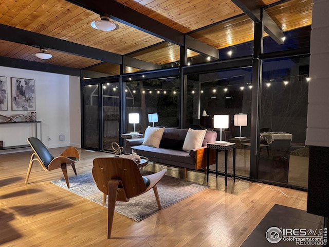 living room featuring beam ceiling, floor to ceiling windows, wooden ceiling, and wood finished floors