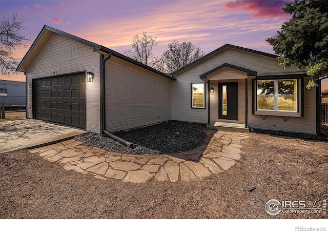 view of front facade with concrete driveway and an attached garage