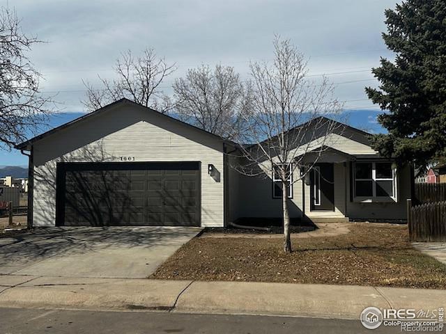 single story home featuring a garage, driveway, and fence