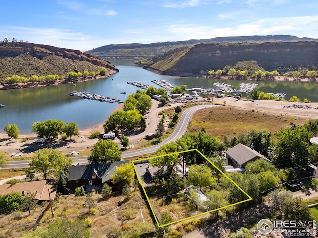 birds eye view of property featuring a water and mountain view