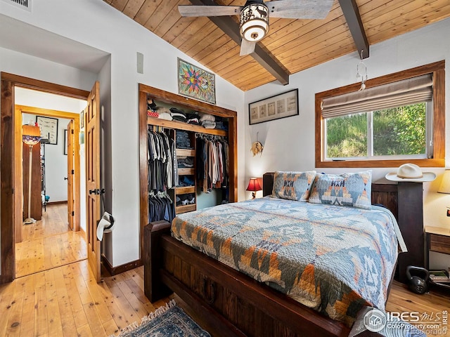 bedroom featuring a closet, wood ceiling, hardwood / wood-style floors, and vaulted ceiling with beams