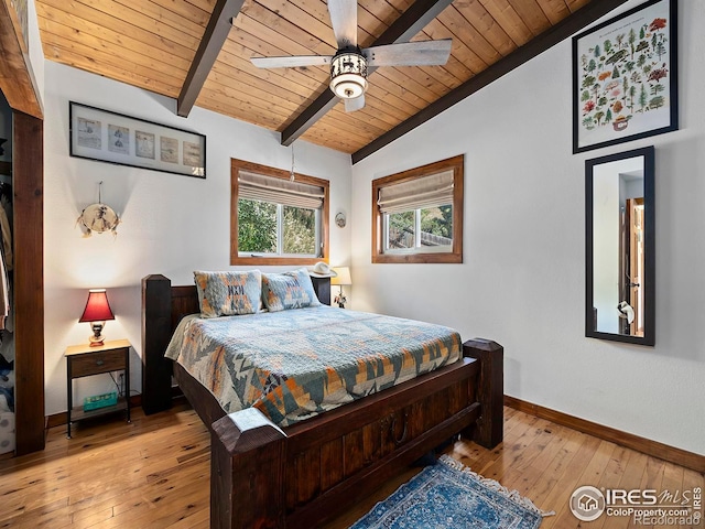 bedroom with vaulted ceiling with beams, ceiling fan, baseboards, wood ceiling, and light wood-type flooring