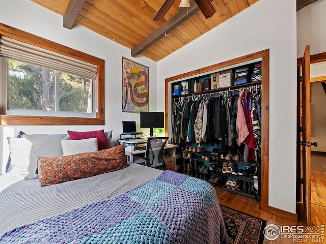 bedroom featuring wood finished floors, vaulted ceiling with beams, wood ceiling, and a closet