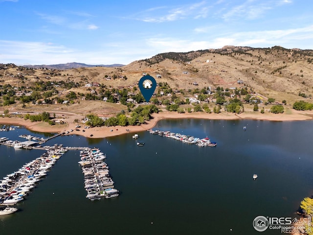 drone / aerial view featuring a water and mountain view