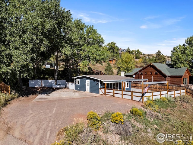 view of front of house with driveway and a wooden deck