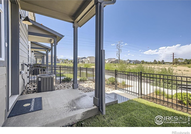 view of patio with cooling unit and fence