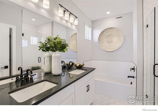 full bathroom featuring a sink, marble finish floor, a stall shower, and a bath