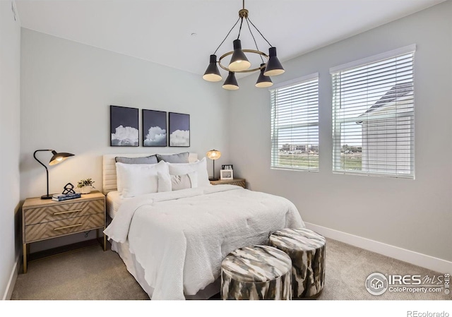 bedroom with baseboards, light carpet, and a notable chandelier