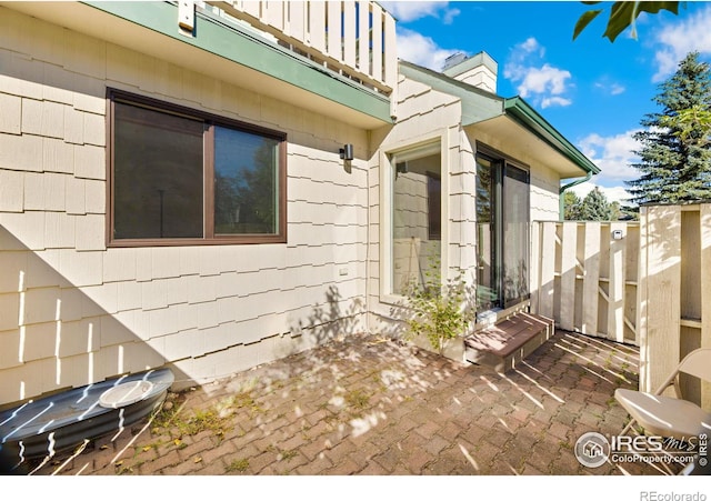 view of home's exterior featuring a patio, a balcony, and a fenced backyard