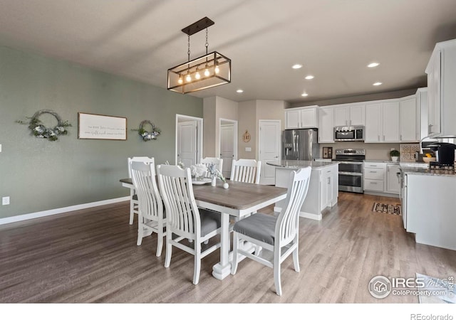 dining space featuring light wood-style flooring, recessed lighting, and baseboards