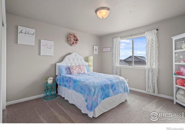 carpeted bedroom with baseboards