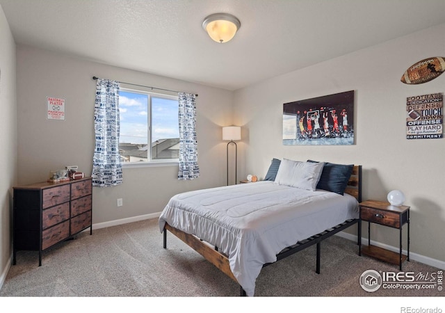 bedroom featuring baseboards and carpet flooring