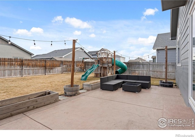 view of playground with outdoor lounge area, a patio, a fenced backyard, and a lawn