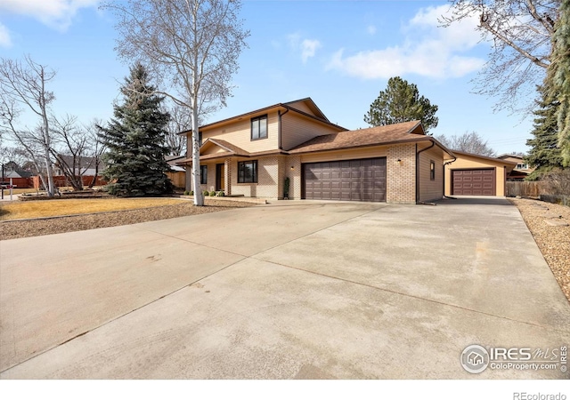 traditional-style house featuring brick siding, concrete driveway, and a garage