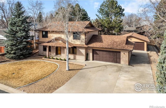 traditional-style home with brick siding, fence, a garage, and roof with shingles