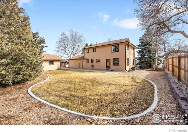 back of property with a lawn, central AC, a patio, and fence