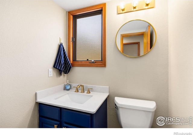 half bath with vanity and toilet