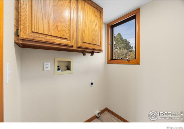 laundry room with hookup for a washing machine, wood finished floors, baseboards, cabinet space, and electric dryer hookup