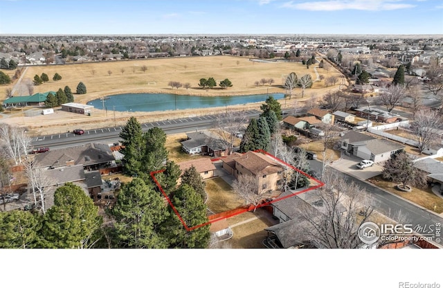 birds eye view of property featuring a residential view and a water view