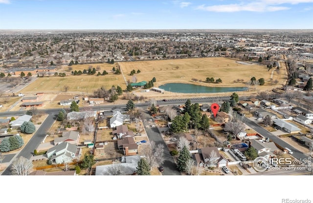 drone / aerial view with a water view and a residential view