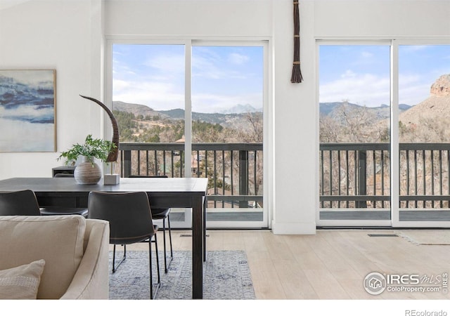 dining space with visible vents, wood finished floors, and a mountain view