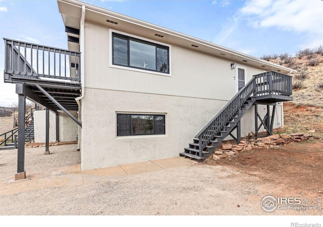 rear view of property with stairway