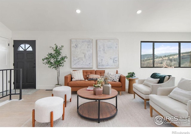 living room featuring recessed lighting, light wood-type flooring, and baseboards