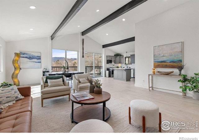 living room featuring beam ceiling, light wood-style flooring, recessed lighting, and a mountain view