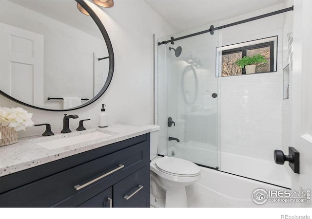 full bathroom with toilet, vanity, and bath / shower combo with glass door