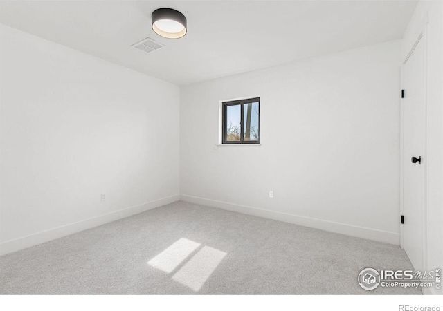 unfurnished room with visible vents, baseboards, and carpet