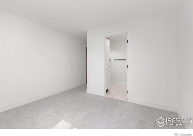 unfurnished bedroom with carpet flooring and baseboards