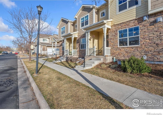 view of front of property with a residential view and stone siding