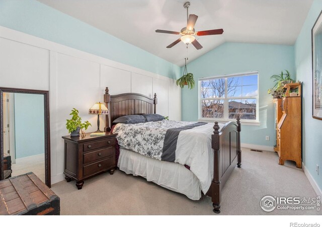 bedroom with a ceiling fan, baseboards, visible vents, vaulted ceiling, and light carpet