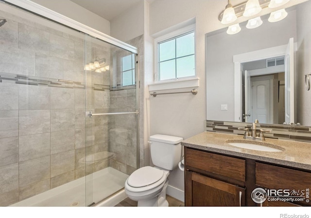 full bathroom with visible vents, a shower stall, toilet, and vanity