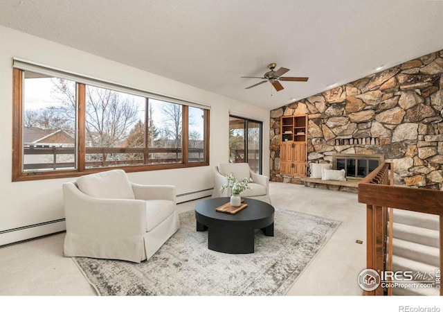 carpeted living area featuring a baseboard radiator, lofted ceiling, a textured ceiling, and a fireplace