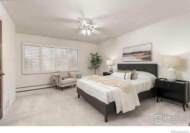 carpeted bedroom featuring a baseboard radiator and a ceiling fan