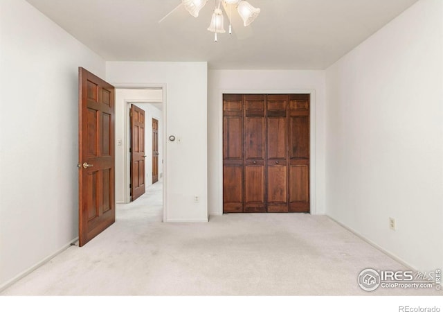 unfurnished bedroom featuring a closet, ceiling fan, and carpet