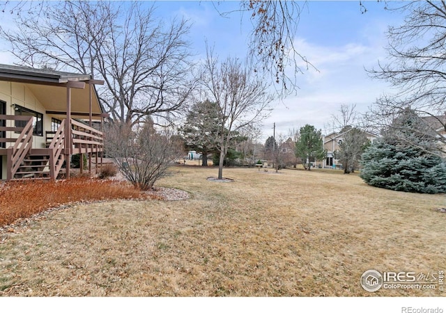 view of yard featuring stairs and a wooden deck