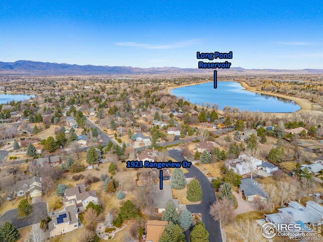 drone / aerial view featuring a water and mountain view