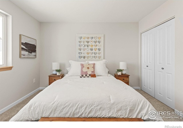 bedroom with a closet, carpet flooring, and baseboards