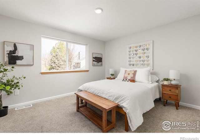 bedroom featuring visible vents, baseboards, and carpet