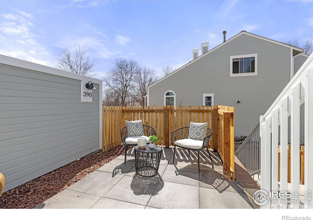 view of patio featuring fence