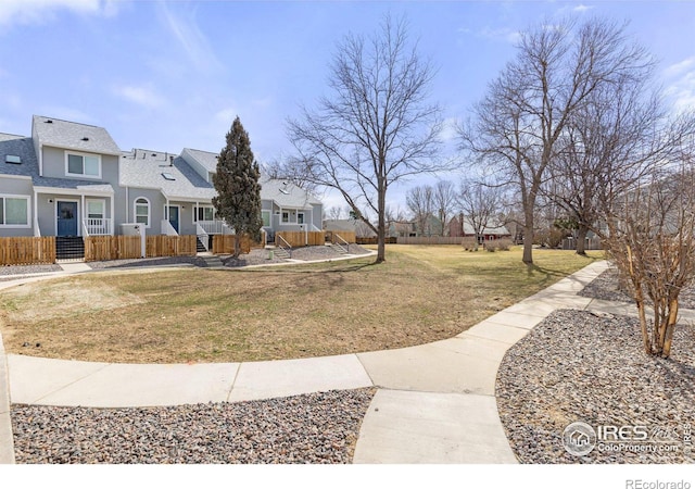 view of yard featuring a residential view and fence